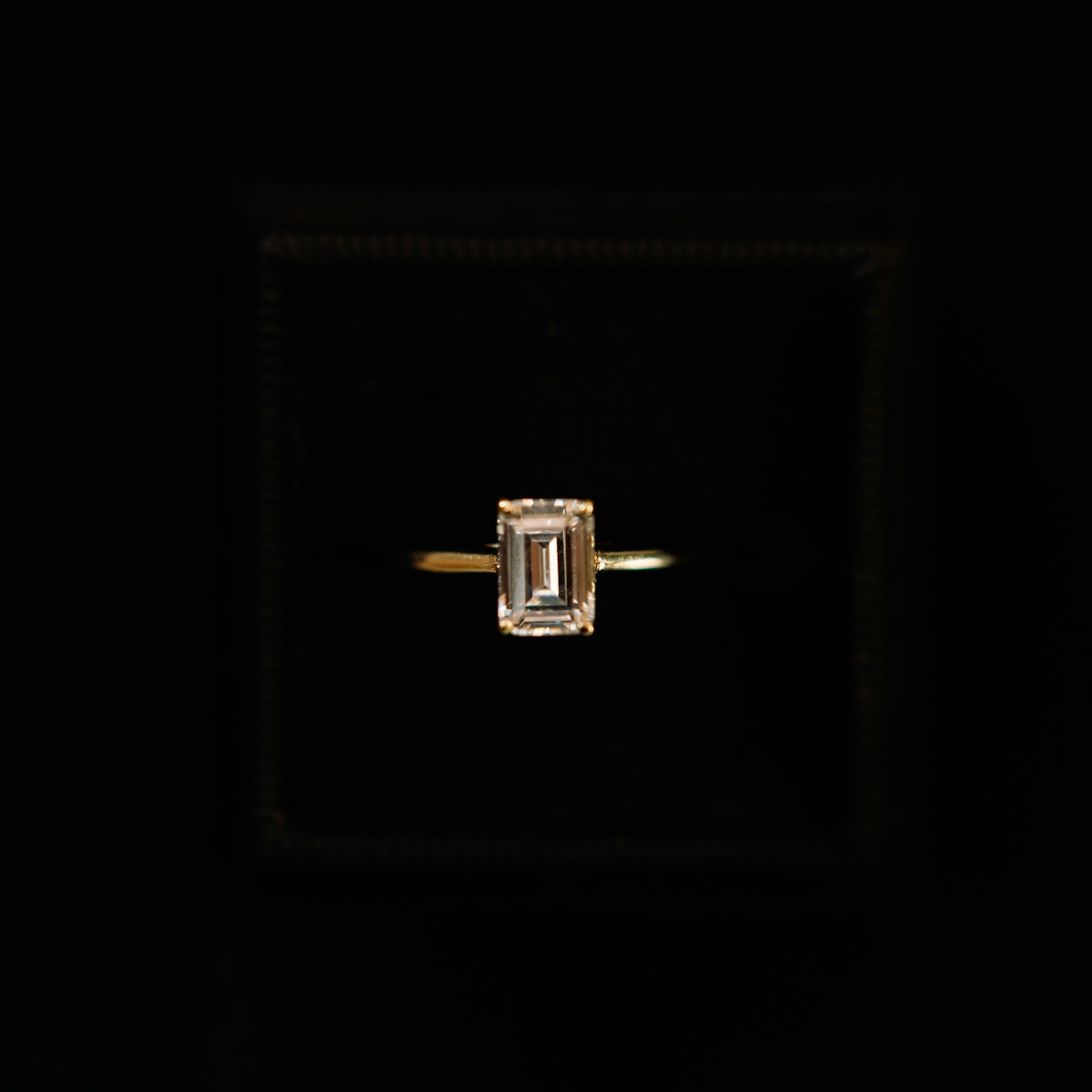 a ring with a square shaped diamond in the middle