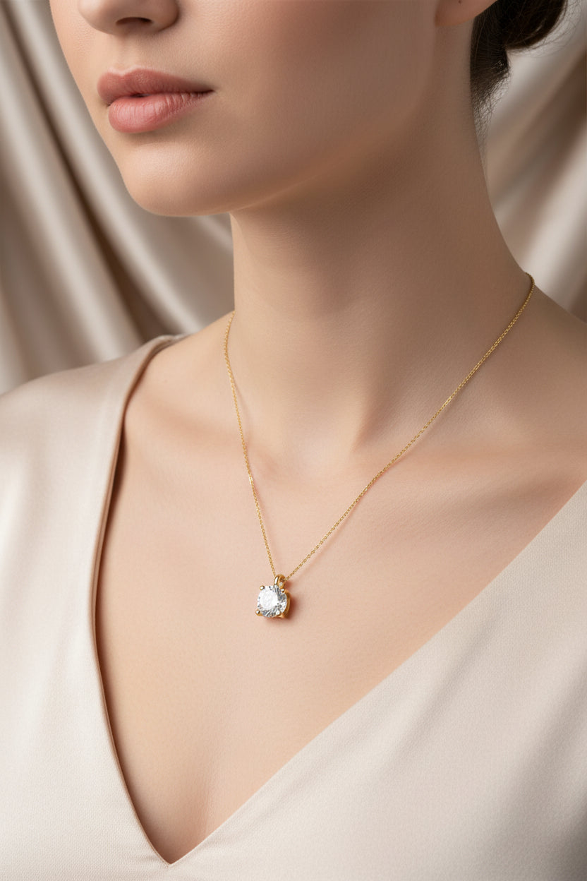 Necklace with a pendant worn by a person against a neutral background